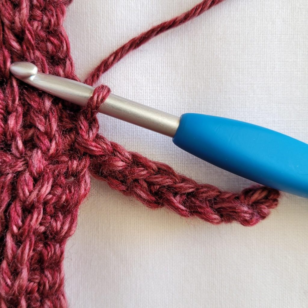 Slip stitching the sleeve trim row into the sleeve body stitches