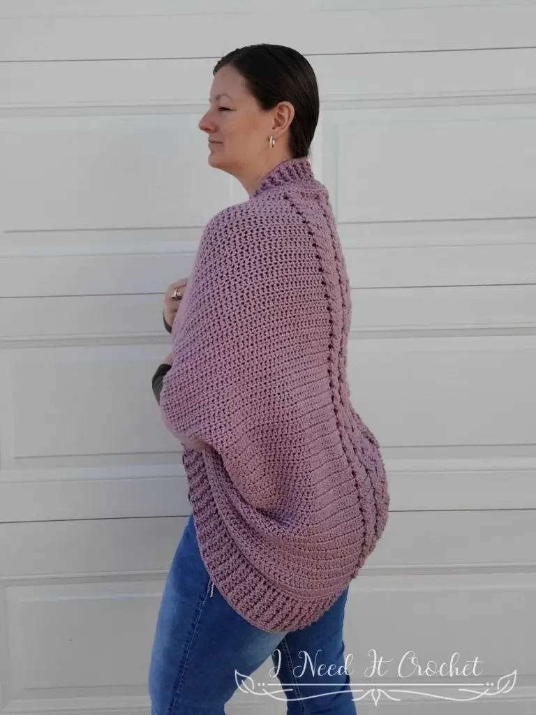 Picture showing a model wearing the Free Crochet Shrug Pattern - Cozy Cabled. 