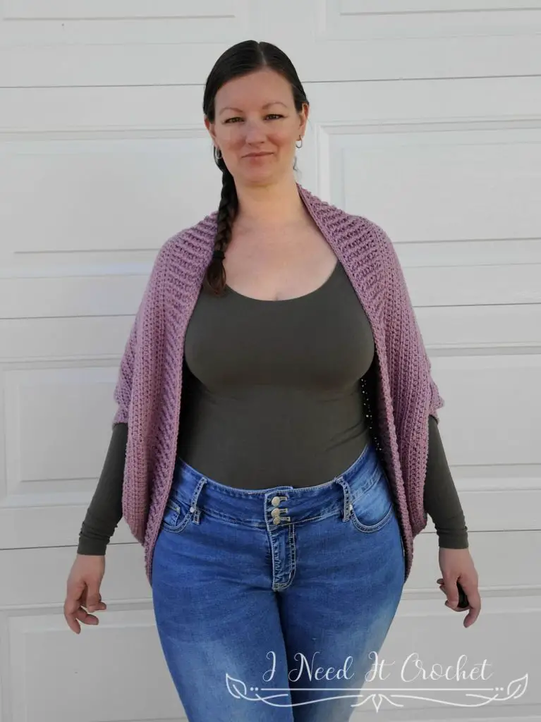 Picture showing a model wearing the Free Crochet Shrug Pattern - Cozy Cabled. 