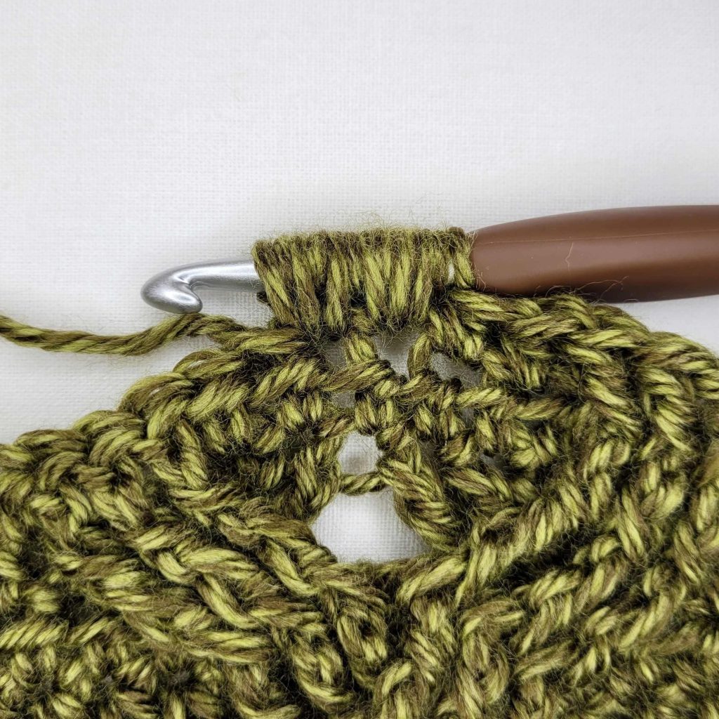 Instructional photo that shows how to make the Morgaine Sweater Scarf. 