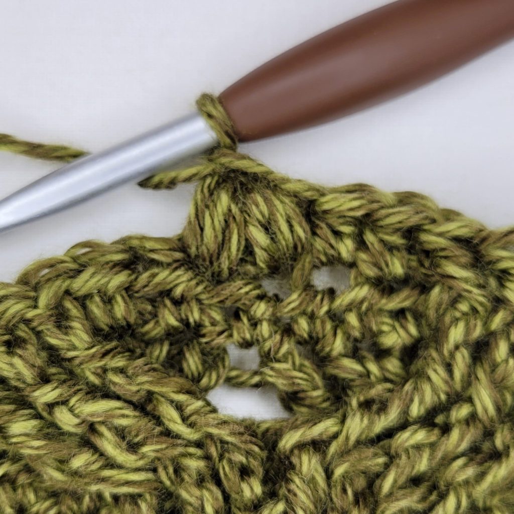 Instructional photo that shows how to make the Morgaine Sweater Scarf. 