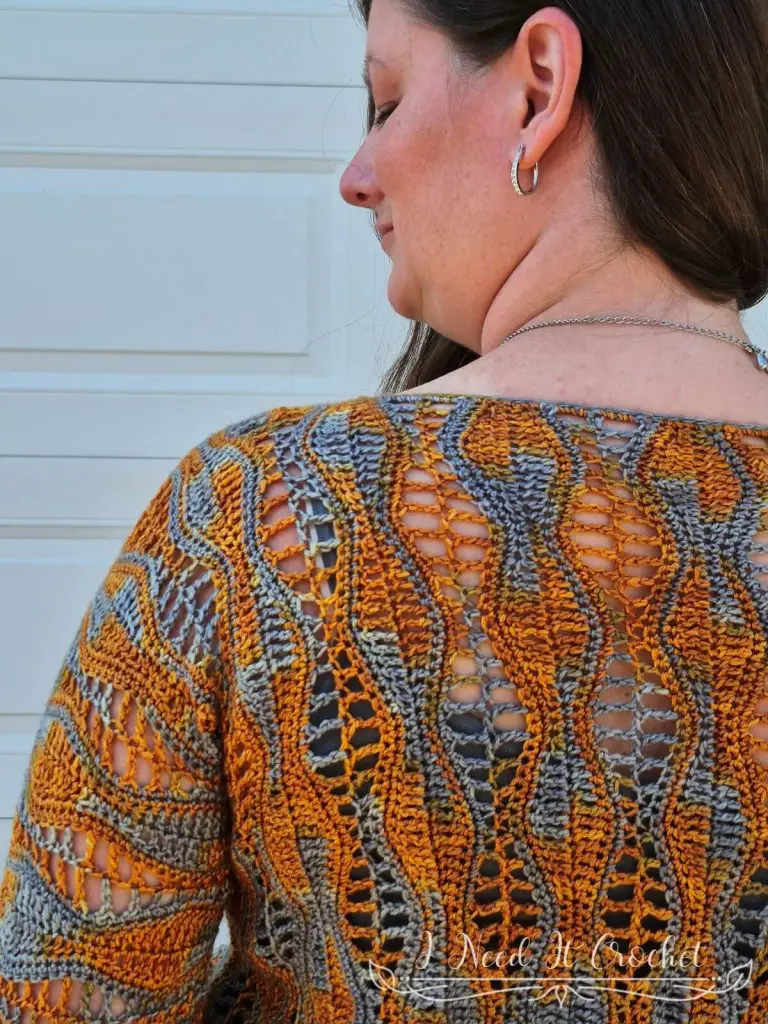 Back view of the crochet blouse showing relaxed fit and lightweight drape