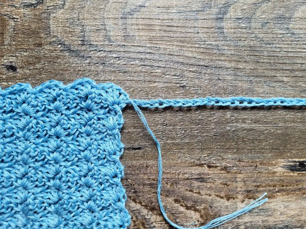 Figure 7 showing how to attach the center long chain to the bottom of the right shoulder.