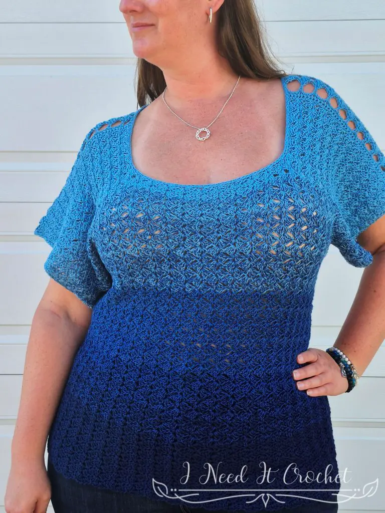 Crochet summer blouse with square neckline and customizable sleeves, handmade using slanted stitch patterns.