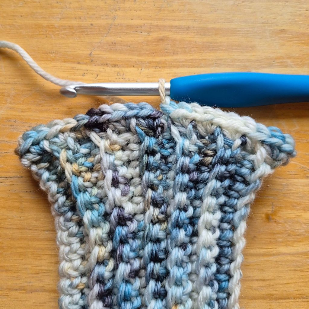 Detail photo of crochet sweater scarf construction and stitch texture