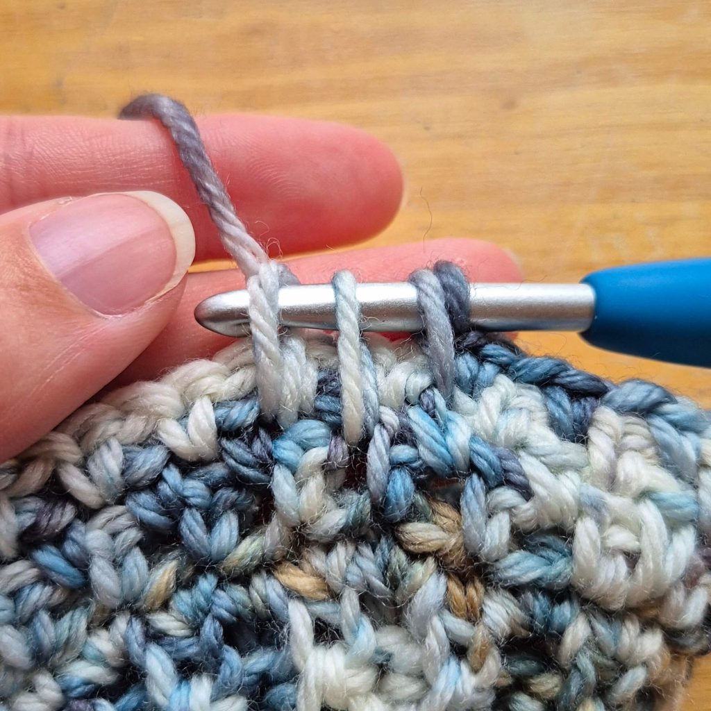 Third spike worked one row down and two stitches to the left