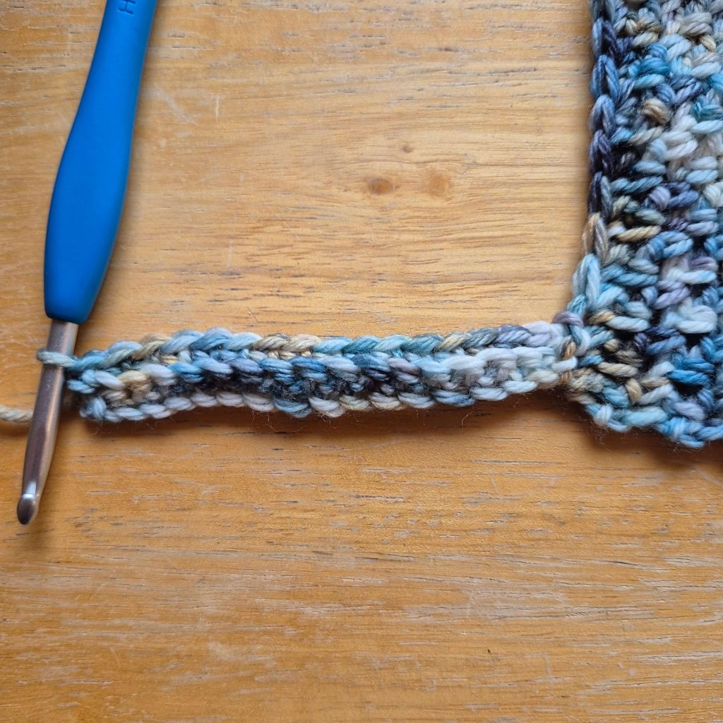 Close-up of textured crochet stitches used in the sweater scarf pattern