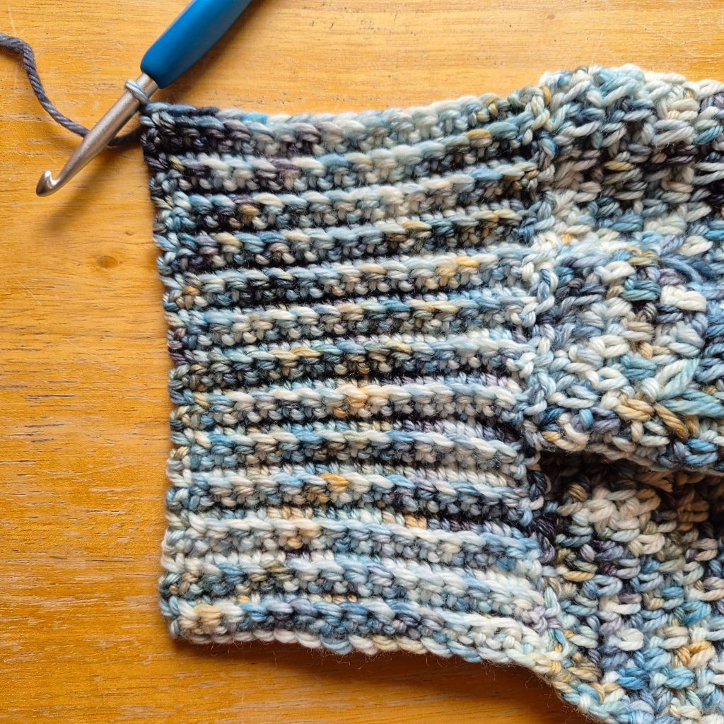 Detail photo of crochet sweater scarf construction and stitch texture