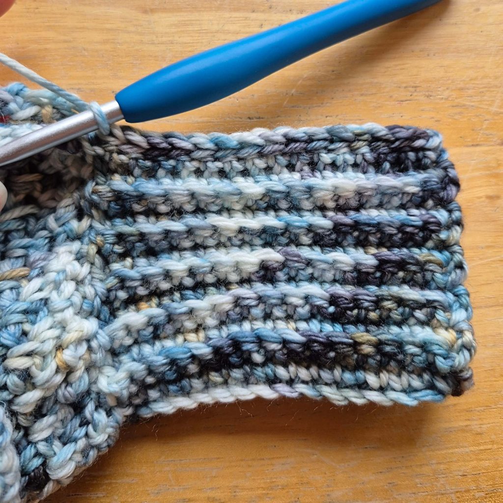 Detail photo of crochet sweater scarf construction and stitch texture