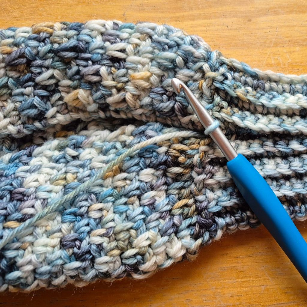 Detail photo of crochet sweater scarf construction and stitch texture