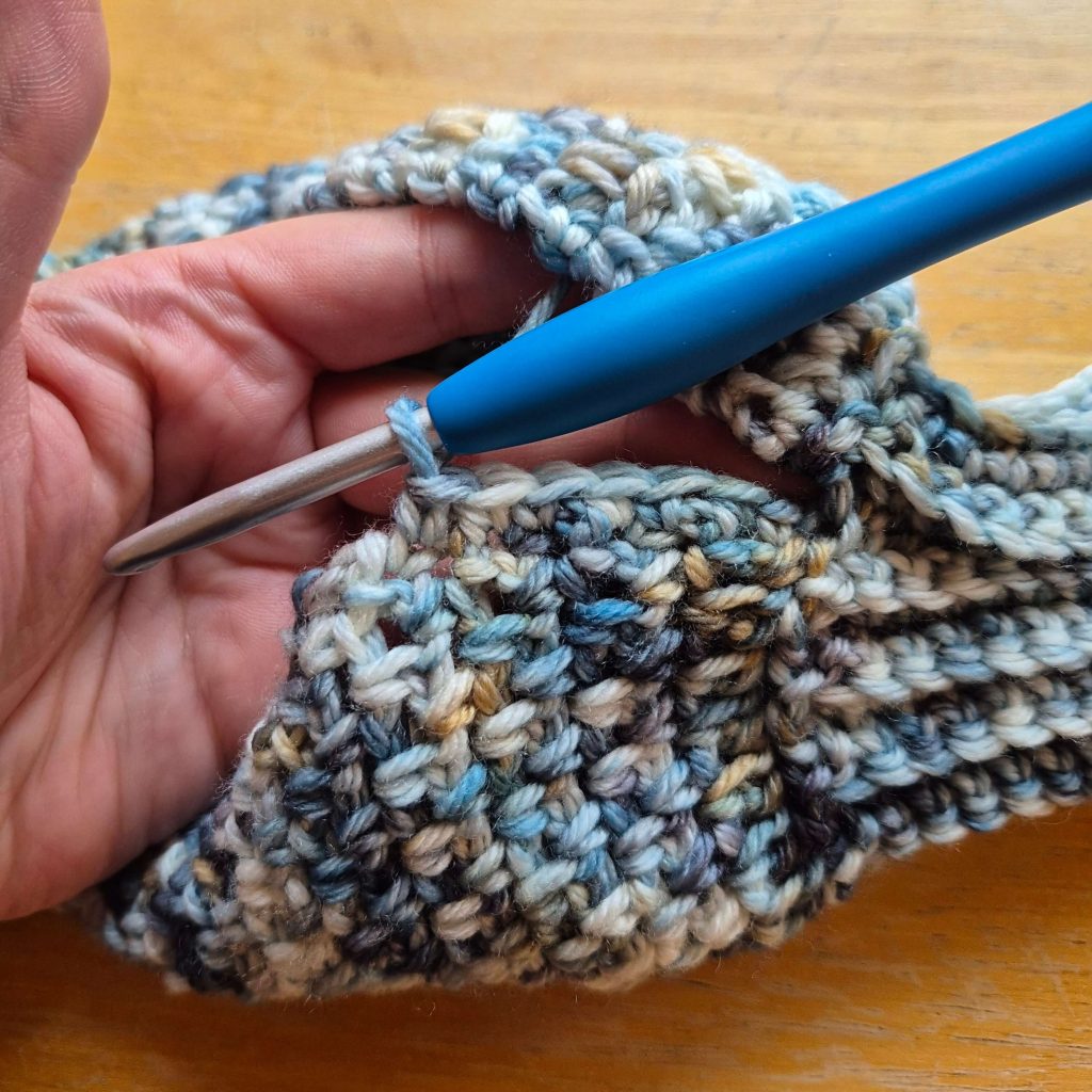 Detail photo of crochet sweater scarf construction and stitch texture