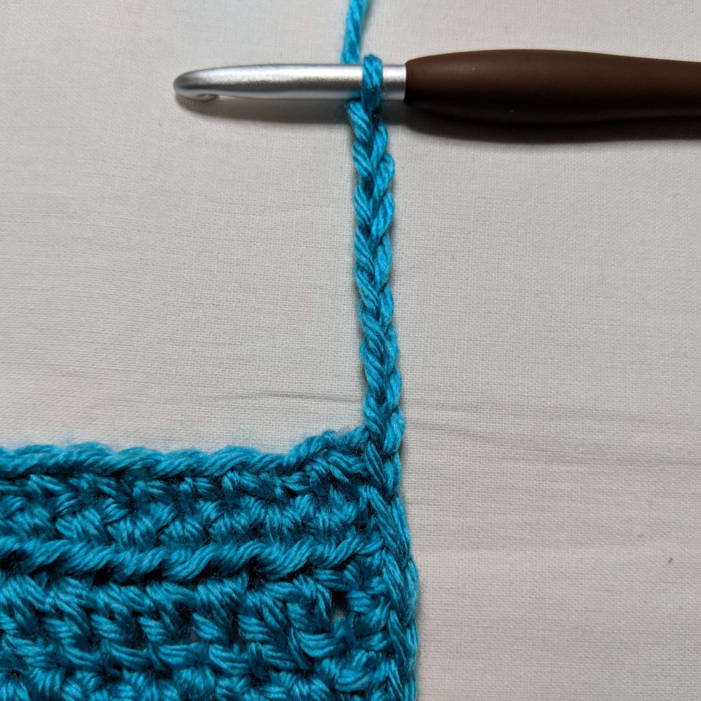 Starting the body trim by chaining eight stitches along the front panel edge