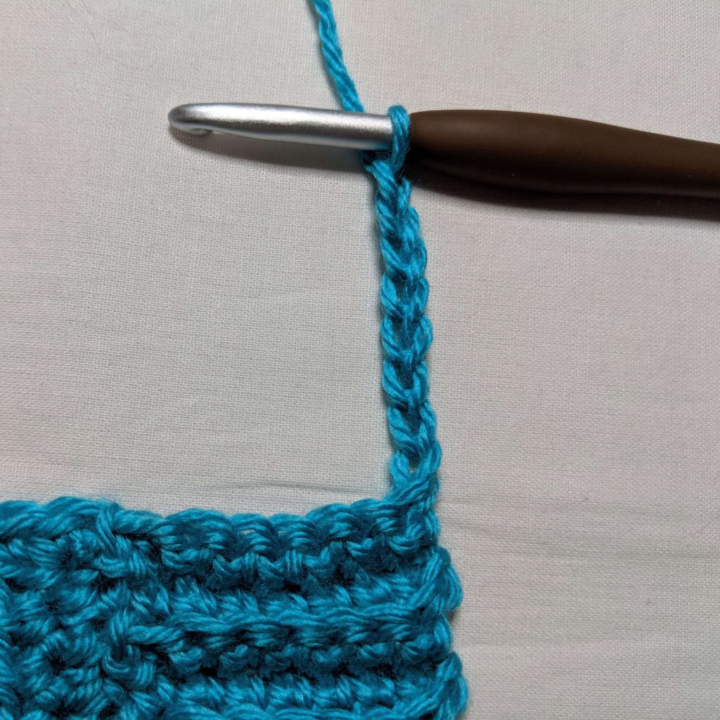 Beginning ribbed trim along the front panel by chaining eight stitches