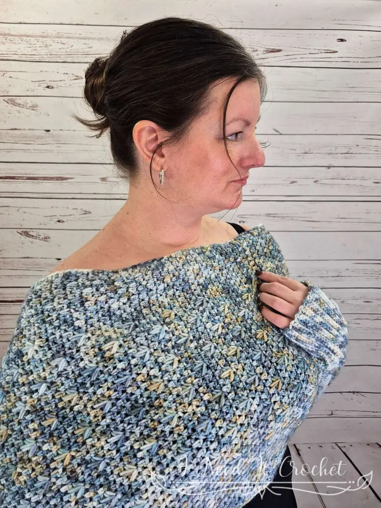 Crochet sweater scarf pattern modeled in blue hand-dyed DK weight yarn