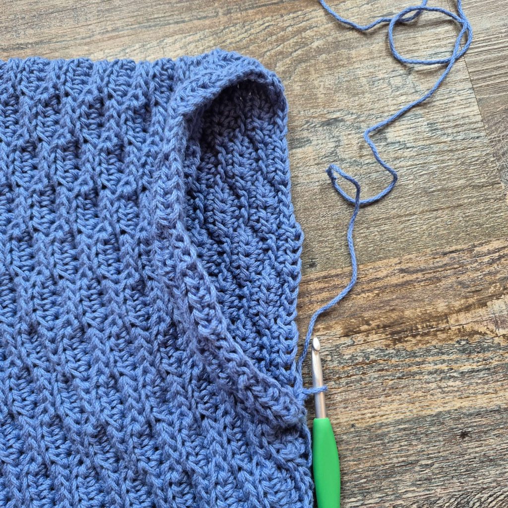 Shows hook joined at bottom of arm hole.