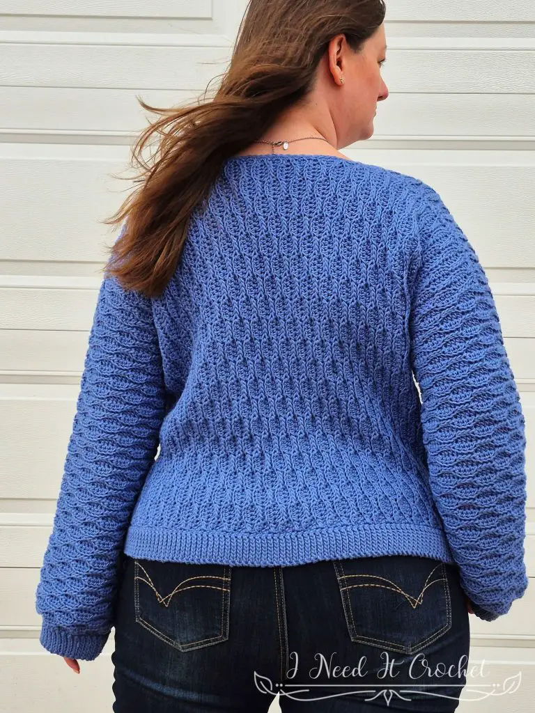Close-up image of model wearing the Free Crochet Sweater Pattern: The Dulcis Pullover.